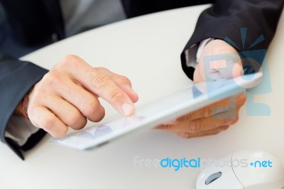 Businessman Finger Pointing To The Screen Of A Digital Tablet Stock Photo