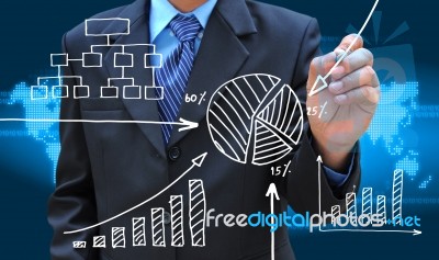 Businessman Hand Drawing Business Graph Stock Photo