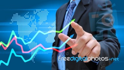 Businessman Hand Drawing Business Graph Stock Photo