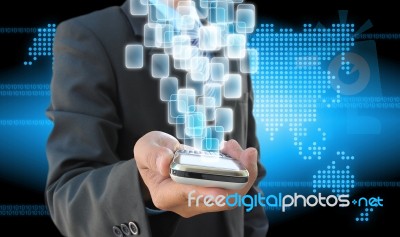 Businessman Hand Holding Mobile Phone And Virtual Buttons Stock Photo