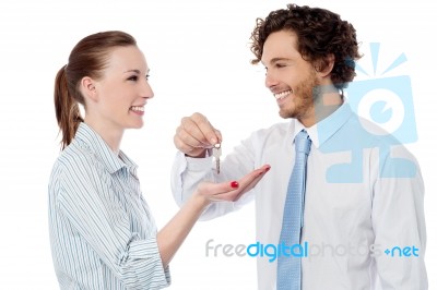 Businessman Handing Over The Key Stock Photo