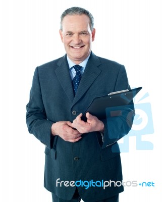 Businessman Holding Clipboard Stock Photo