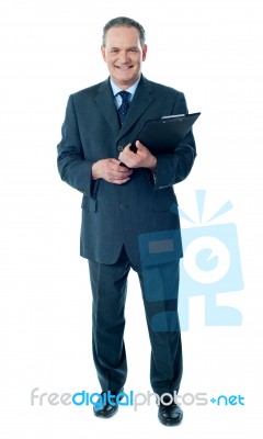 Businessman holding clipboard Stock Photo