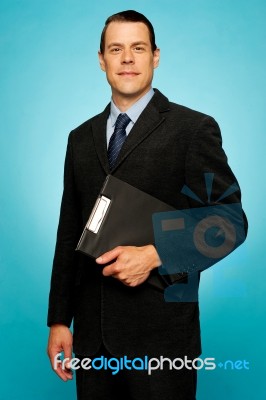 Businessman Holding Clipboard Stock Photo