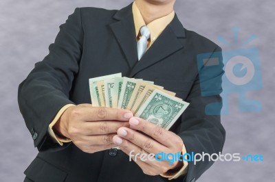 Businessman Holding Money Cash Dollars In Hands Stock Photo