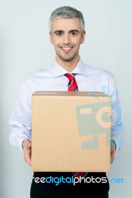 Businessman Holding Packed Carton Stock Photo