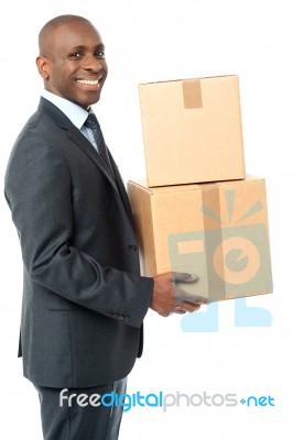 Businessman Holding Packed Cartons Stock Photo