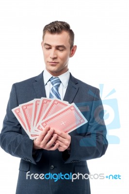 Businessman Holding Play Cards Stock Photo