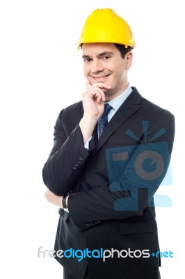 Businessman Holds His Hand On His Chin Stock Photo