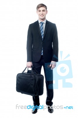 Businessman In Black Suit Posing With Bag Stock Photo