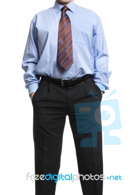 Businessman In Blue Shirt Standing With Hands In Pockets Stock Photo