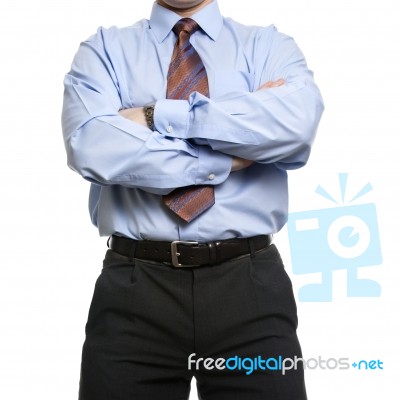 Businessman In Blue Shirt Stands With Crossed Folded Hands Stock Photo