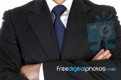 Businessman In Suit With Crossed Arms Stock Photo