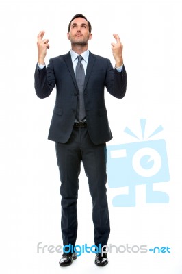 Businessman Looking Above, Fingers Crossed Stock Photo