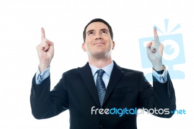 Businessman Looking And Pointing Upwards Stock Photo