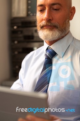 Businessman Middle-aged Working From Home With A Tablet Stock Photo