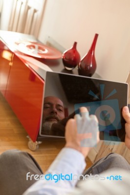 Businessman Middle-aged Working From Home With A Tablet Stock Photo