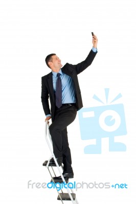 Businessman On Ladder Stock Photo