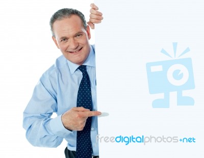 Businessman Peeping Behind board Stock Photo