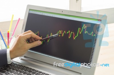 Businessman Point And Analyze Forex Graph Or Stock Graph By Pen Stock Photo