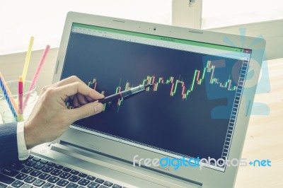 Businessman Point And Analyze Forex Graph Or Stock Graph By Pen On Blue Vintage Style Stock Photo