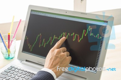 Businessman Point And Analyze Forex Graph Or Stock Graph By Right Finger Stock Photo