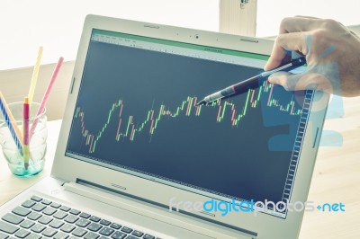 Businessman Point And Analyze Forex Graph Or Stock Graph By Use Pen In Right Hand On Blue Vintage Style Stock Photo