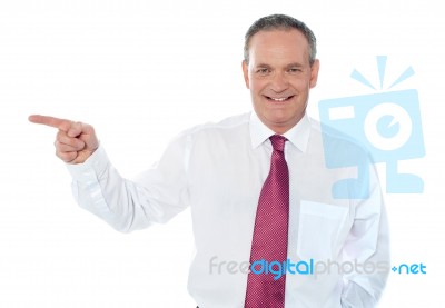 Businessman Pointing Away Stock Photo