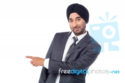 Businessman Pointing Away Over White Stock Photo