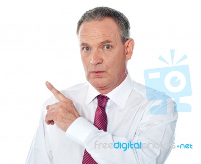 Businessman Pointing Backward Stock Photo