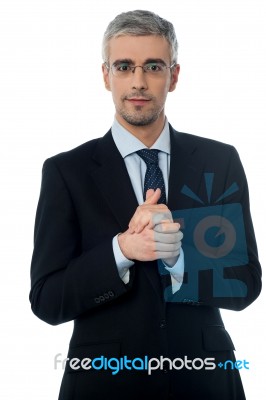 Businessman Posing With Clasped Hands Stock Photo