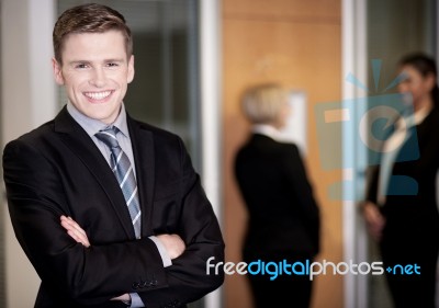 Businessman Posing With Smart Associates Behind Stock Photo