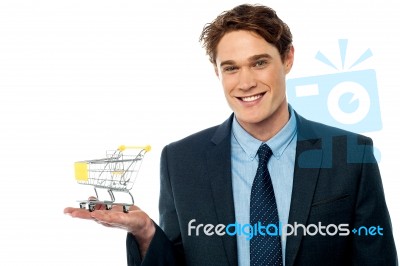 Businessman Presenting Shopping Cart Stock Photo