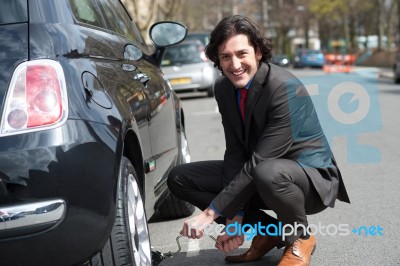 Businessman Repairing Car Roadside Stock Photo