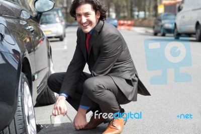 Businessman Repairing Car Roadside Stock Photo