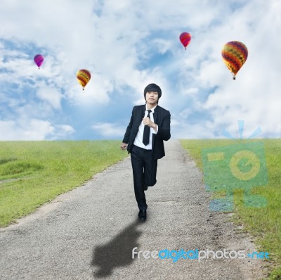 Businessman Running On Road Stock Photo