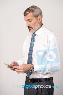 Businessman Scrolling His Contact List Stock Photo