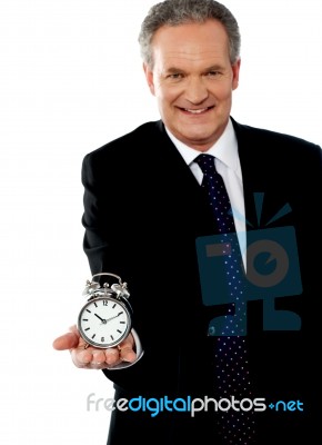 Businessman Showing Alarm Clock Stock Photo