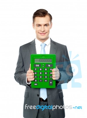 Businessman Showing Big Calculator Stock Photo