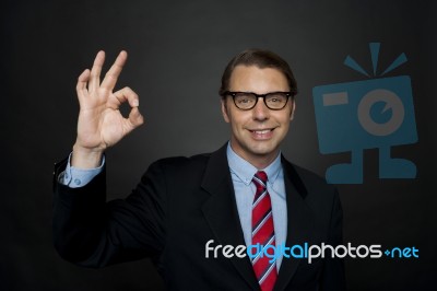 Businessman Showing Ok Sign Stock Photo