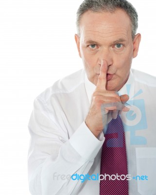 Businessman Showing Silence Gesture Stock Photo