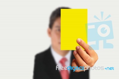 Businessman Showing Yellow Paper Stock Photo