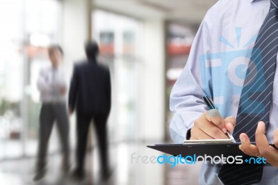 Businessman Signing A Document Stock Photo