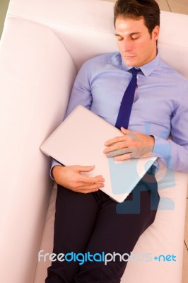 Businessman Sleeping Couch Holding Laptop Stock Photo