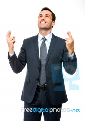 Businessman Smiling Fingers Crossed Stock Photo