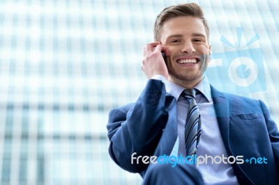 Businessman Talking On Phone Outdoors Stock Photo