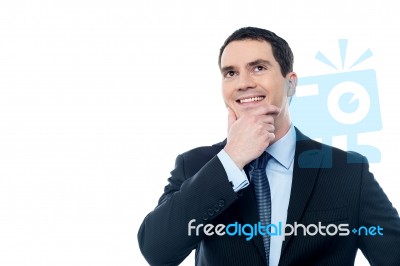 Businessman Thinking With Hand On Chin Stock Photo