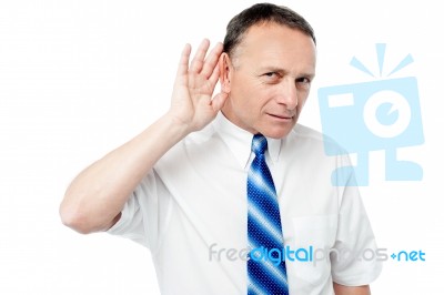 Businessman Trying To Listen Something Stock Photo