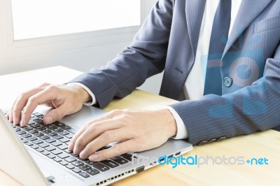 Businessman Typing Or Working With Laptop Or Notebook Stock Photo