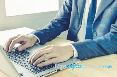 Businessman Typing Or Working With Laptop Or Notebook Vintage Style Stock Photo